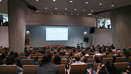Picture from the end of a full lecture hall while a talk is being held